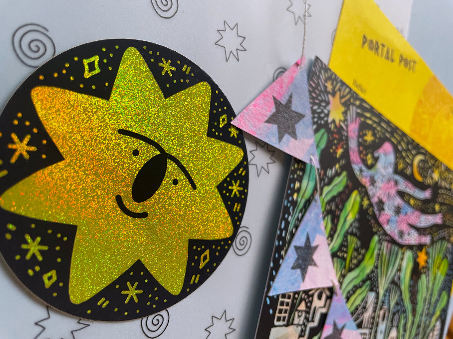 Colorful glittery star-shaped sticker with a face on a white background